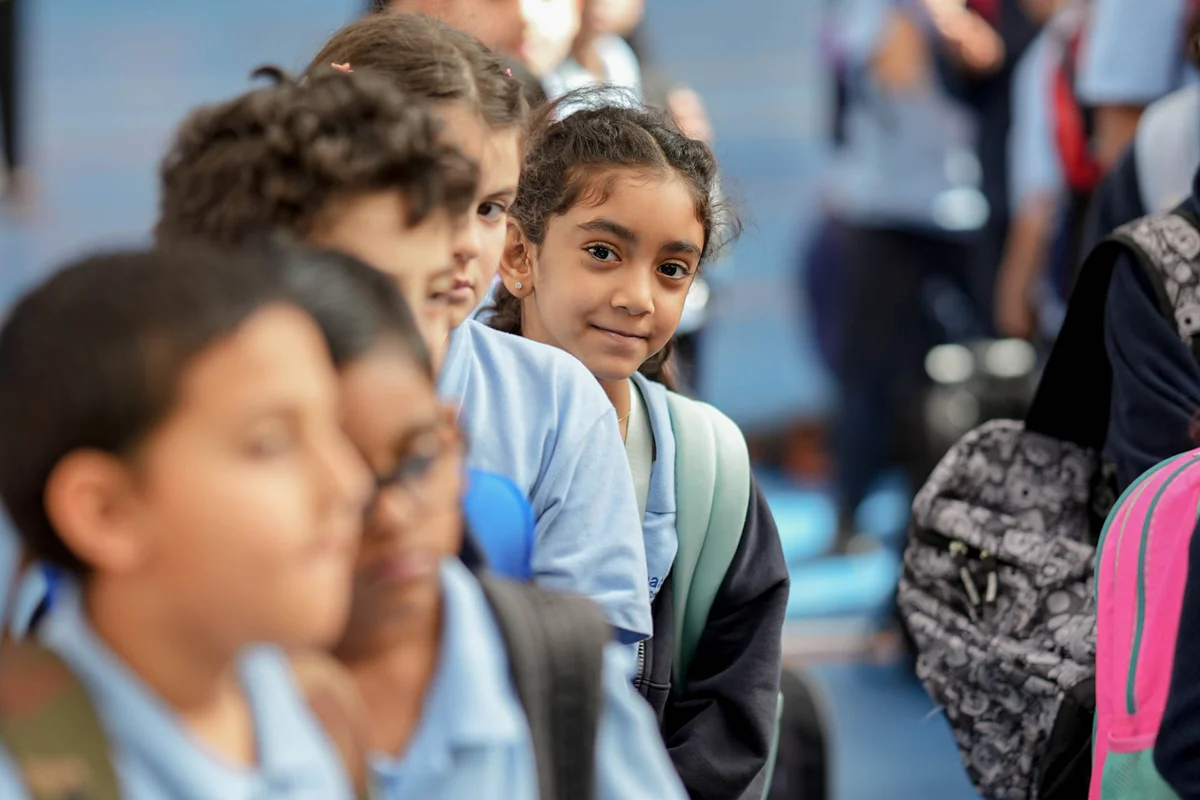 Young students with backpacks on their shoulders